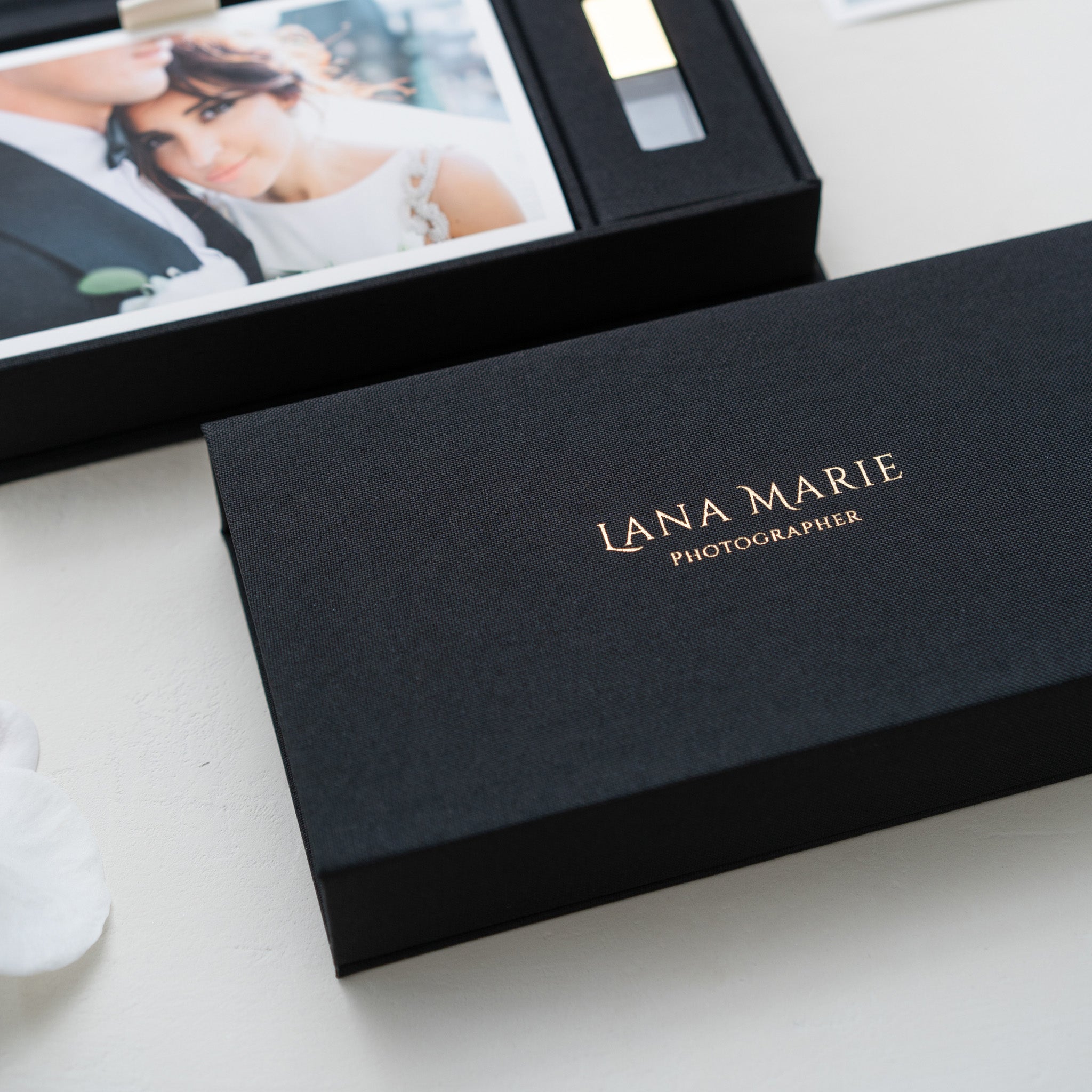 A black box with the name 'Lana Marie Photographer' printed on it, along with a USB flash drive inside the box.