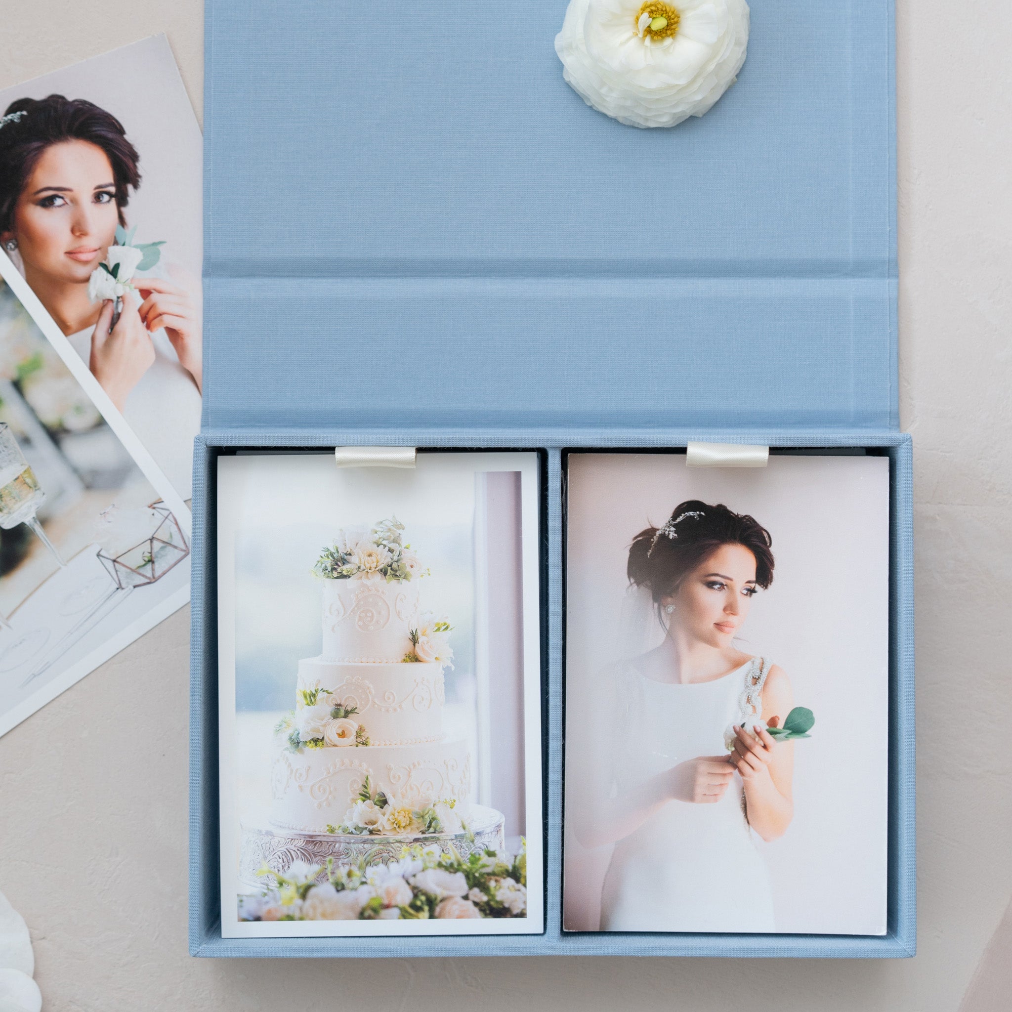 A blue photo album with two pictures of a woman, one of which is a close-up of a cake.