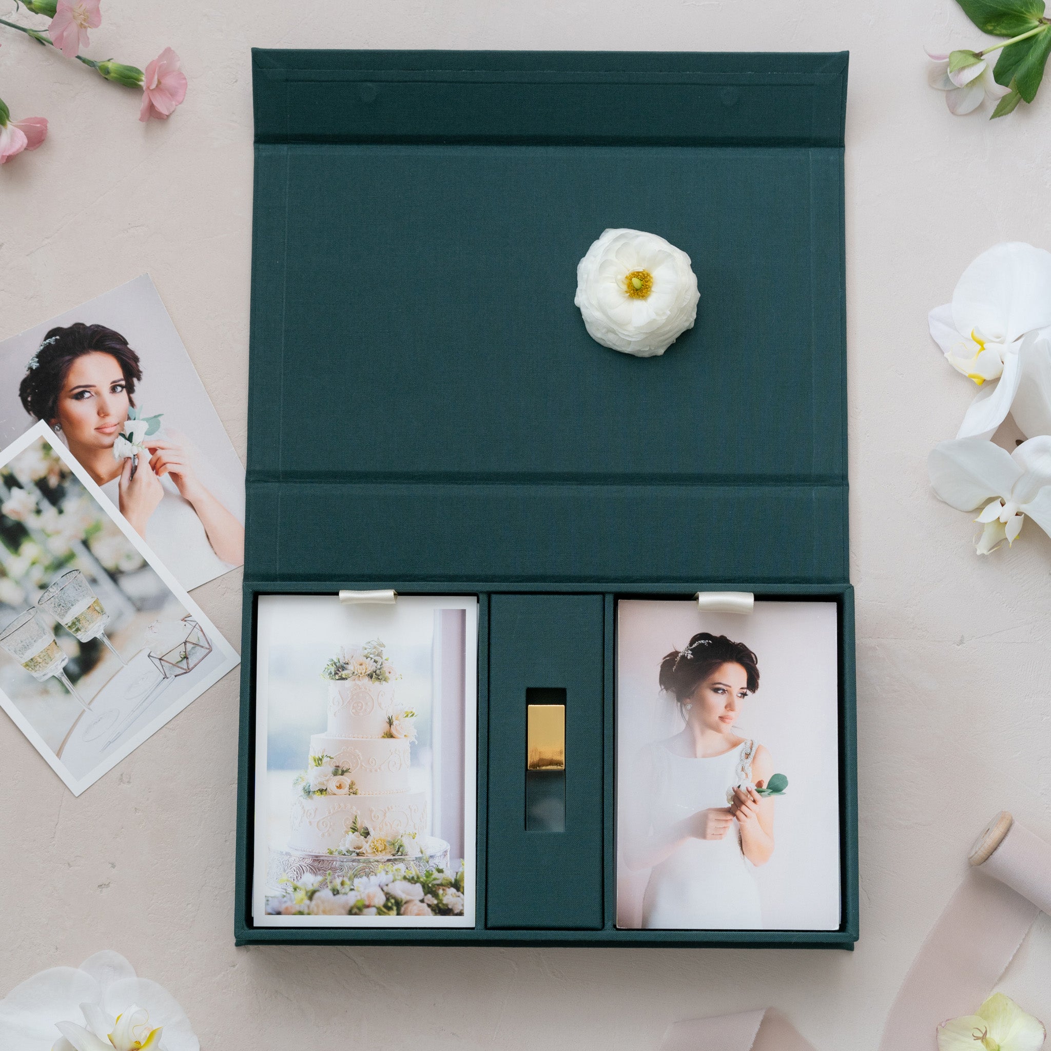 a green box containing two photographs, one of a woman and one of a cake, along with a white flower.